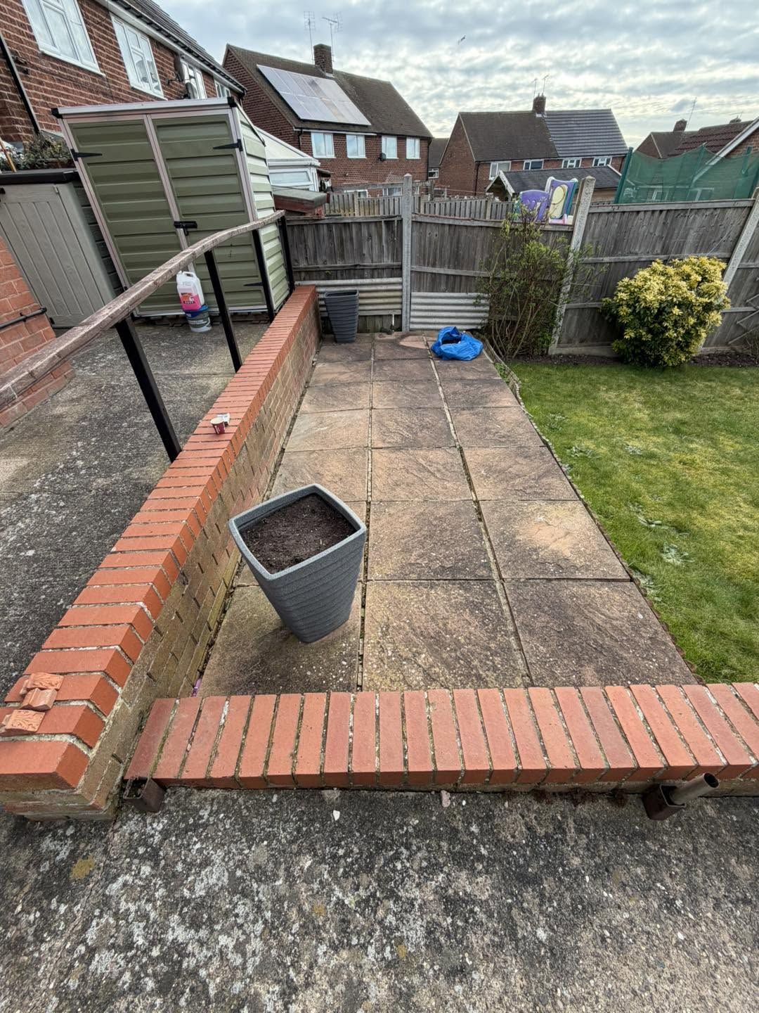 Worn path beside a low brick wall