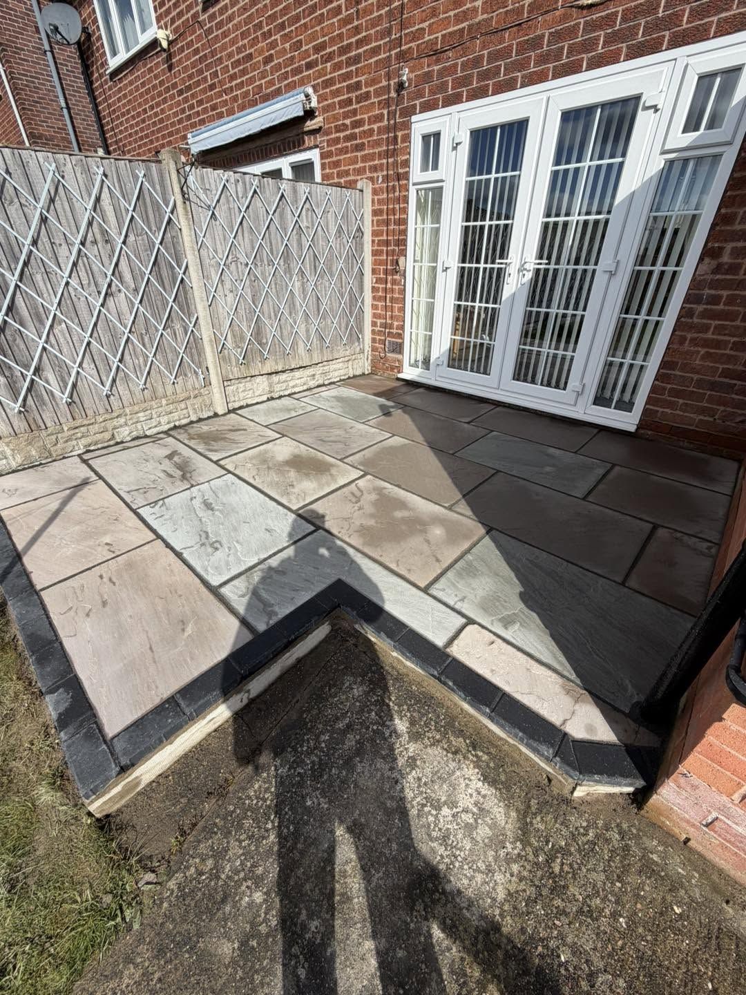 New two-tone slab patio outside the same back door