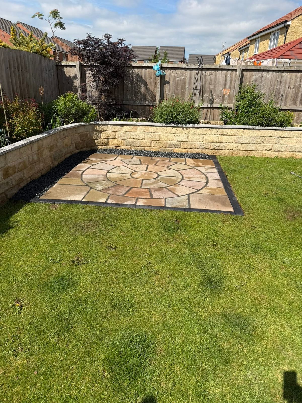Circular patio and stone raised bed