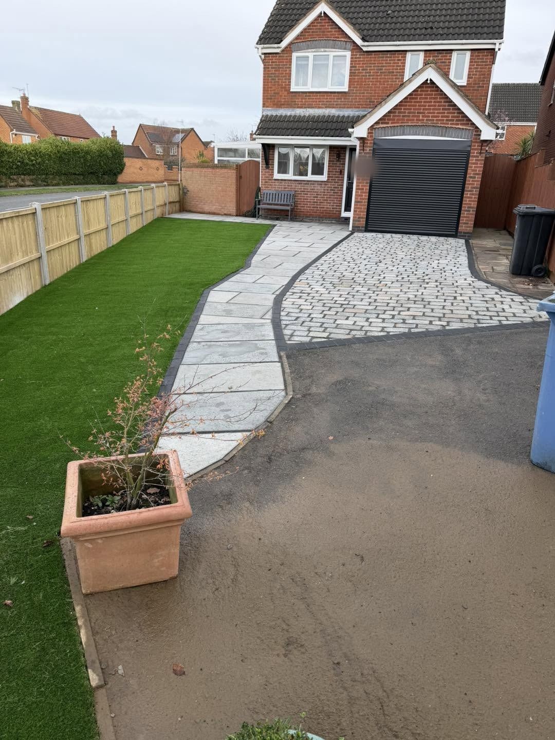 Front path and a sett border to the drive