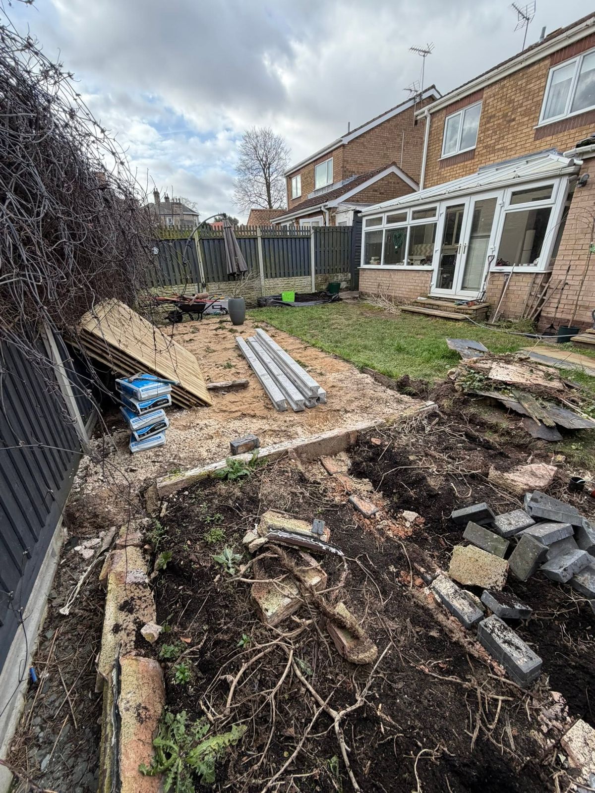 Garden part way through clearance, with roots and rubble