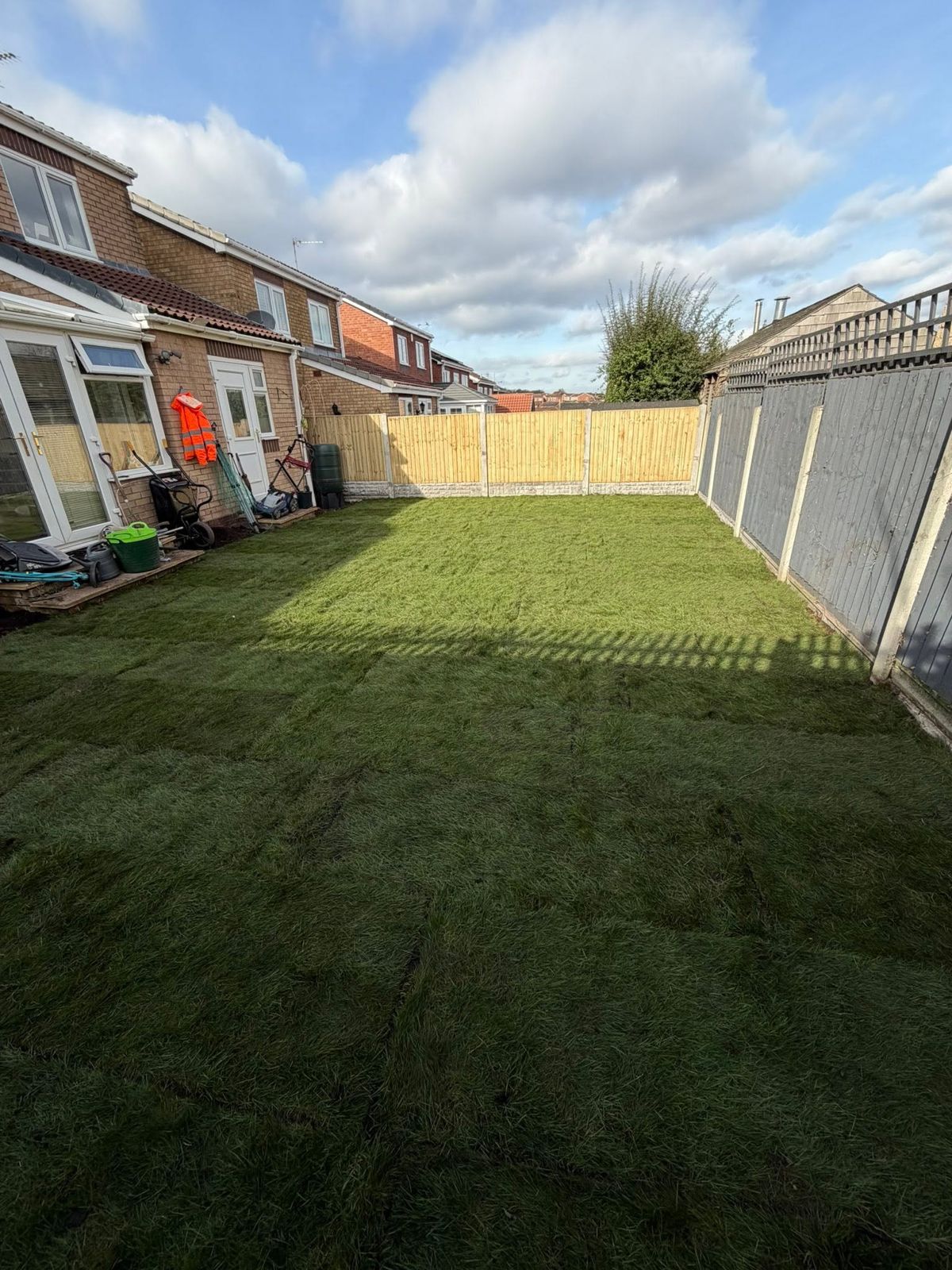 The same garden with a level new lawn and fencing
