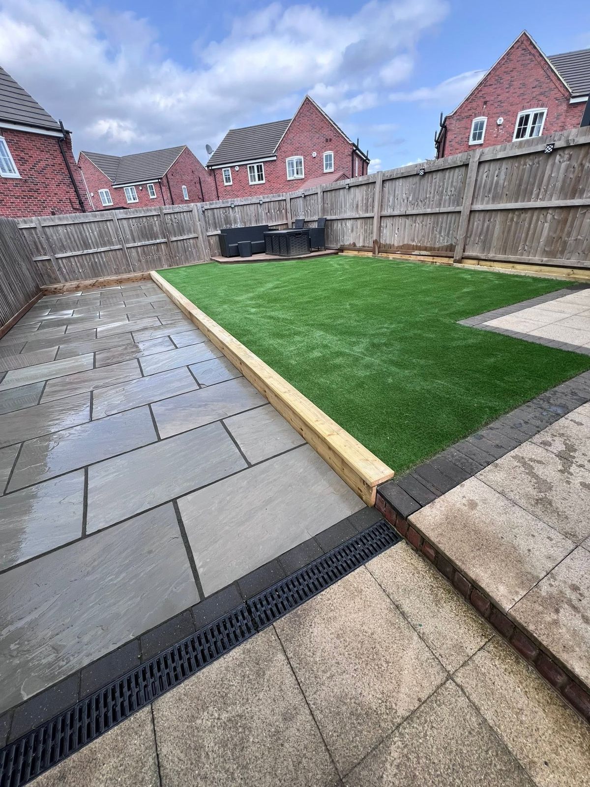 New lawn with a timber sleeper edge beside the patio