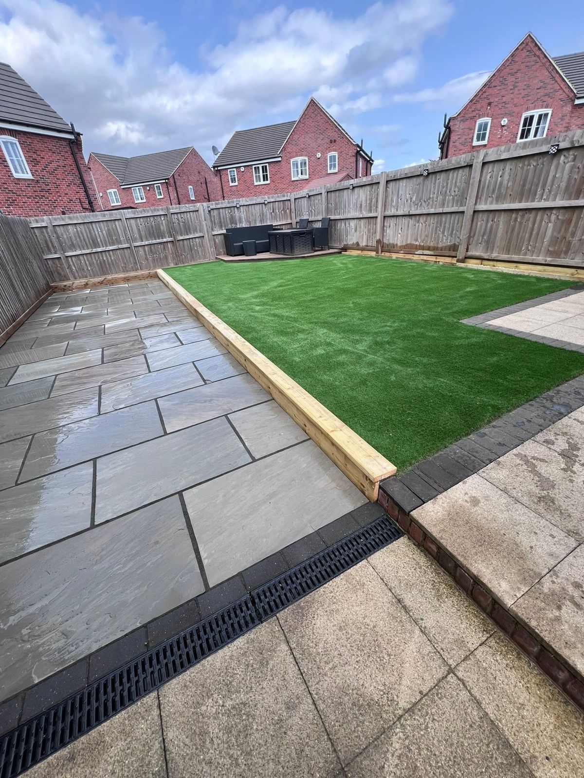 Lawn and patio with a drainage channel