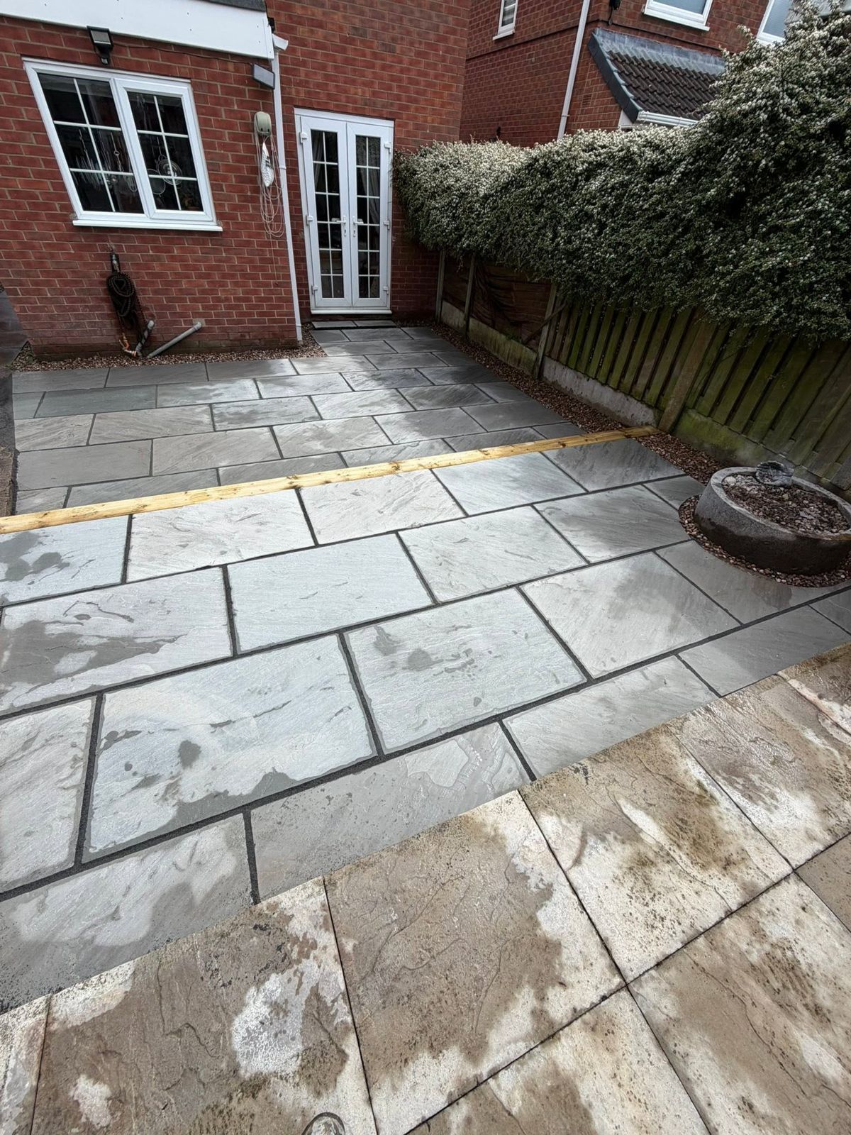 The same garden with a new grey slab patio