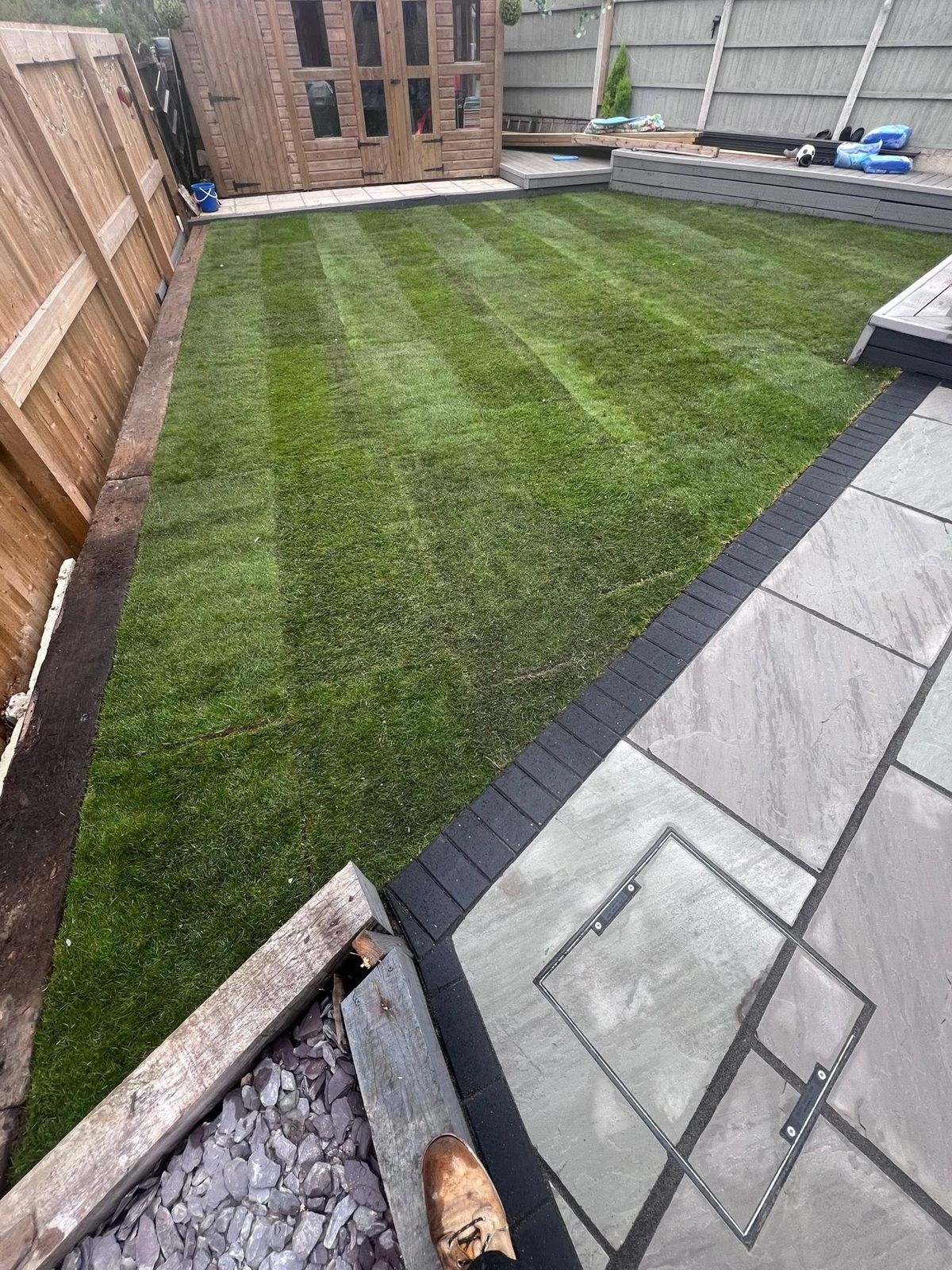 New turf beside a grey patio