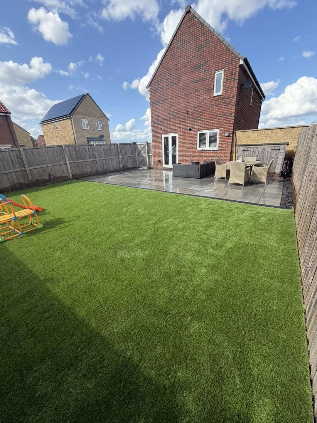 Patio and lawn behind a new build