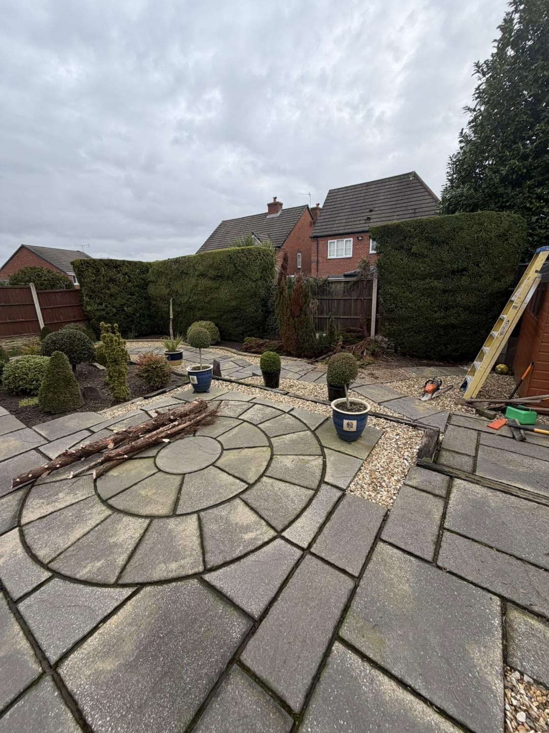 Circular patio stained green before cleaning