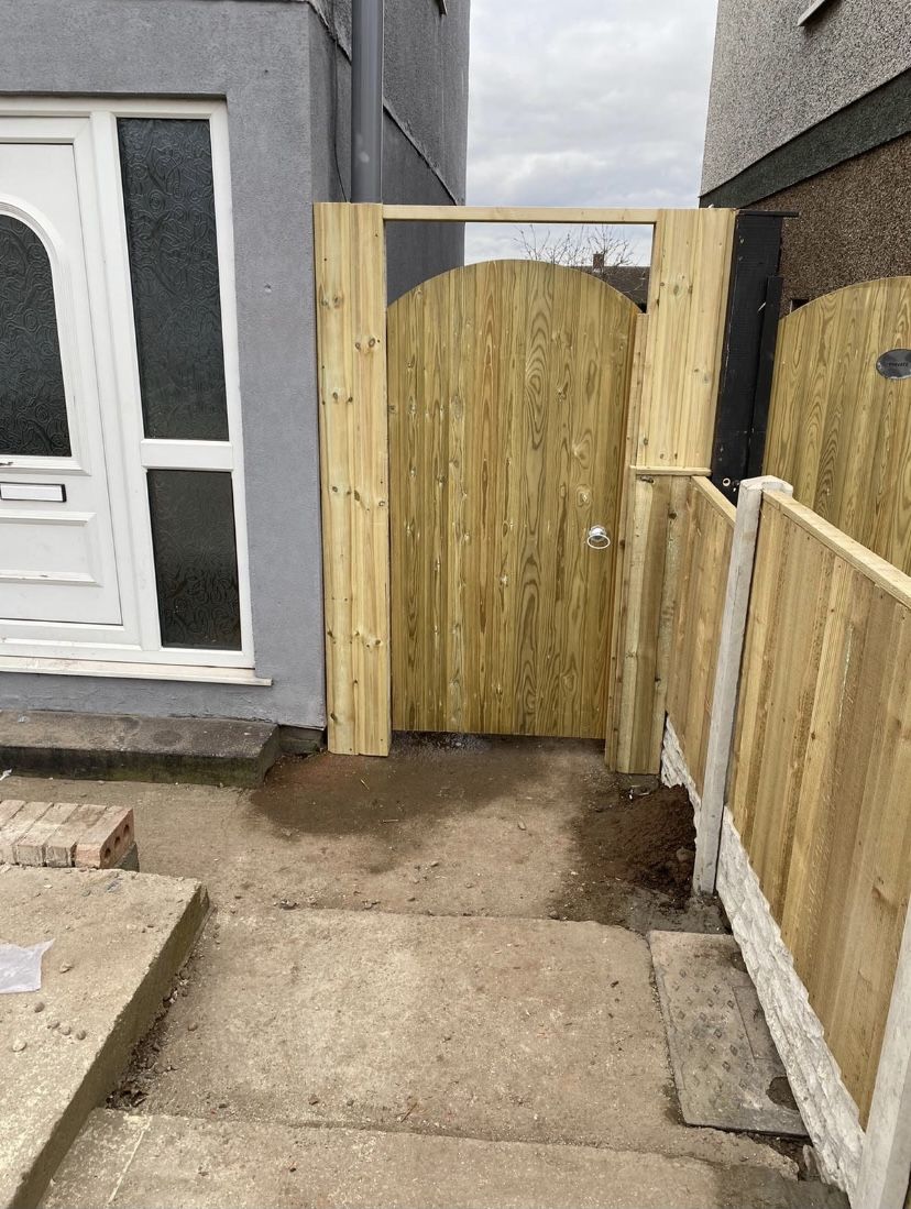 Arched timber side gate and fence beside a front door