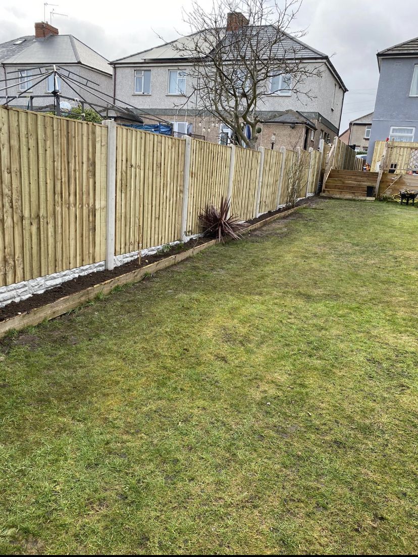 Long back garden with new close-board fencing on concrete posts