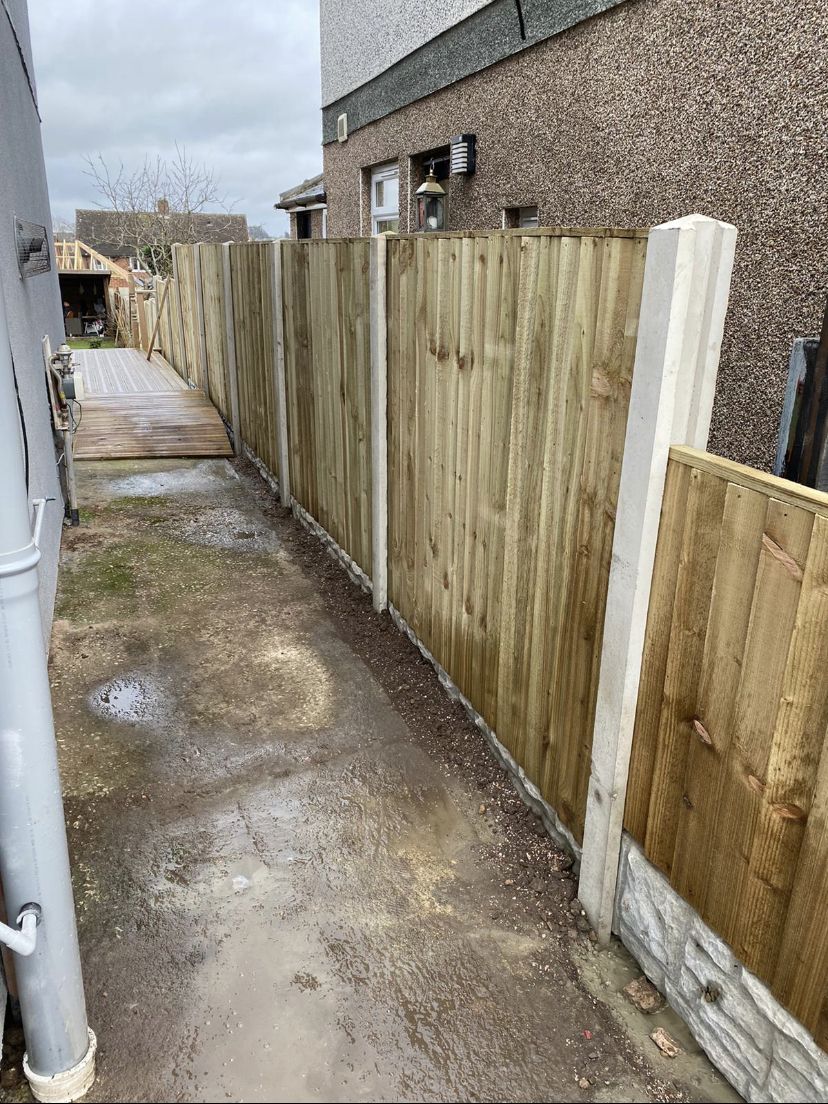 New close-board fence running down a side passage